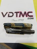Metal cylindrical tool resting on a wrapped package on a white surface with a bold pink-outlined 'VDTM C' logo and '.COM' text; handwritten 'Since 1993' below.