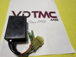 Black automotive relay with multi-colored wires and a yellow connector on a white surface.