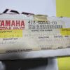 Worn Yamaha Genuine Parts box label with red YAMAHA text and a barcode showing part number 4EX-85540-00, along with shipping and item details on a yellow background