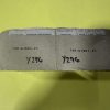 Worn cardboard package with a white perforated label showing 'ORDERED ITEM NUMBER' and 'ORDER NO.' on a bright yellow background.