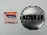 Yamaha genuine parts label beside a round chrome Yamaha emblem cap.