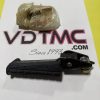 Small Yamaha motor part wrapped in plastic resting on a white sheet with pink/black 'VDMC' text visible underneath