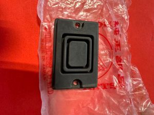 Black recessed cabinet pull handle with nested square frames on a red surface; has screw holes at top and bottom.