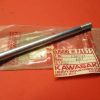 Long silver hex bolt with threaded end, resting on a Kawasaki Genuine Parts bag (motorcycle part).