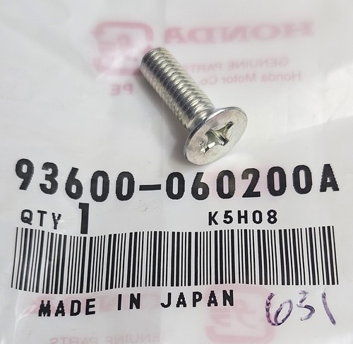 Close-up of a silver Phillips screw on a plastic bag with a barcode and 'MADE IN JAPAN' text beside it.