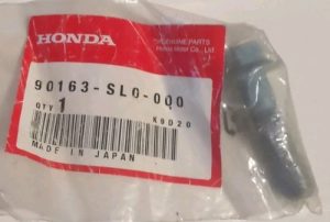 Honda genuine parts bag with a small black automotive part; label reads 90163-SLO-000 and Made in Japan.