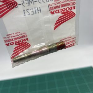 Metal bolt protruding from a clear plastic bag with red Honda Genuine Parts branding.