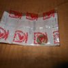 Crumpled white plastic bag with red Honda logos spread on a wooden surface on a table