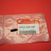Pink plastic bag with a Honda part label reading 90012-426-000; a small black pin rests on the bag on a red surface.