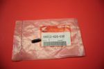 Pink plastic bag with a Honda part label reading 90012-426-000; a small black pin rests on the bag on a red surface.