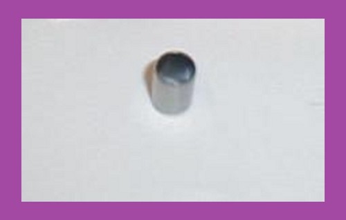 Gray cylindrical pipe stub protruding from a white wall.