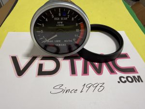 Yamaha tachometer gauge showing 0–12 ×1000 RPM with a visible redline, and indicators for high beam, neutral, and brake lining.