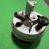 Metallic mechanical component with a threaded outlet and an adjustable knob on a green backdrop.