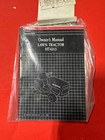 Compact black box labeled 'Chess Manual' with a grid/checker design, shrink-wrapped and placed on a bright red surface.