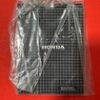 Honda air filter in clear plastic packaging on a red background.