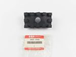 Black plastic rectangular component with raised edge tabs and a central circular hole, placed above a Suzuki genuine parts bag labeled 44541-34500.