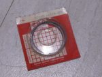 Red Suzuki motor parts packaging with a circular metal seal ring inside, Made in Japan label visible.