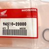 Honda genuine parts bag with red label reading 94510-20000, quantity 1,Made in Japan, plus a small circular metal retaining ring beside the bag.