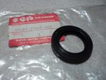 Black rubber oil seal next to Suzuki genuine parts packaging, part number 09283-27010-000, on a plastic bag.