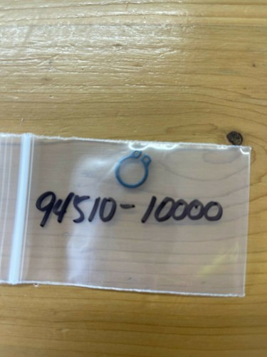 Small resealable plastic bag on a wooden table with the handwritten number 94510-10000 and a blue ring drawing on it.